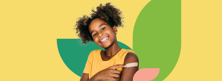 Youth smiling and pointing to their arm with a vaccination bandage on it.